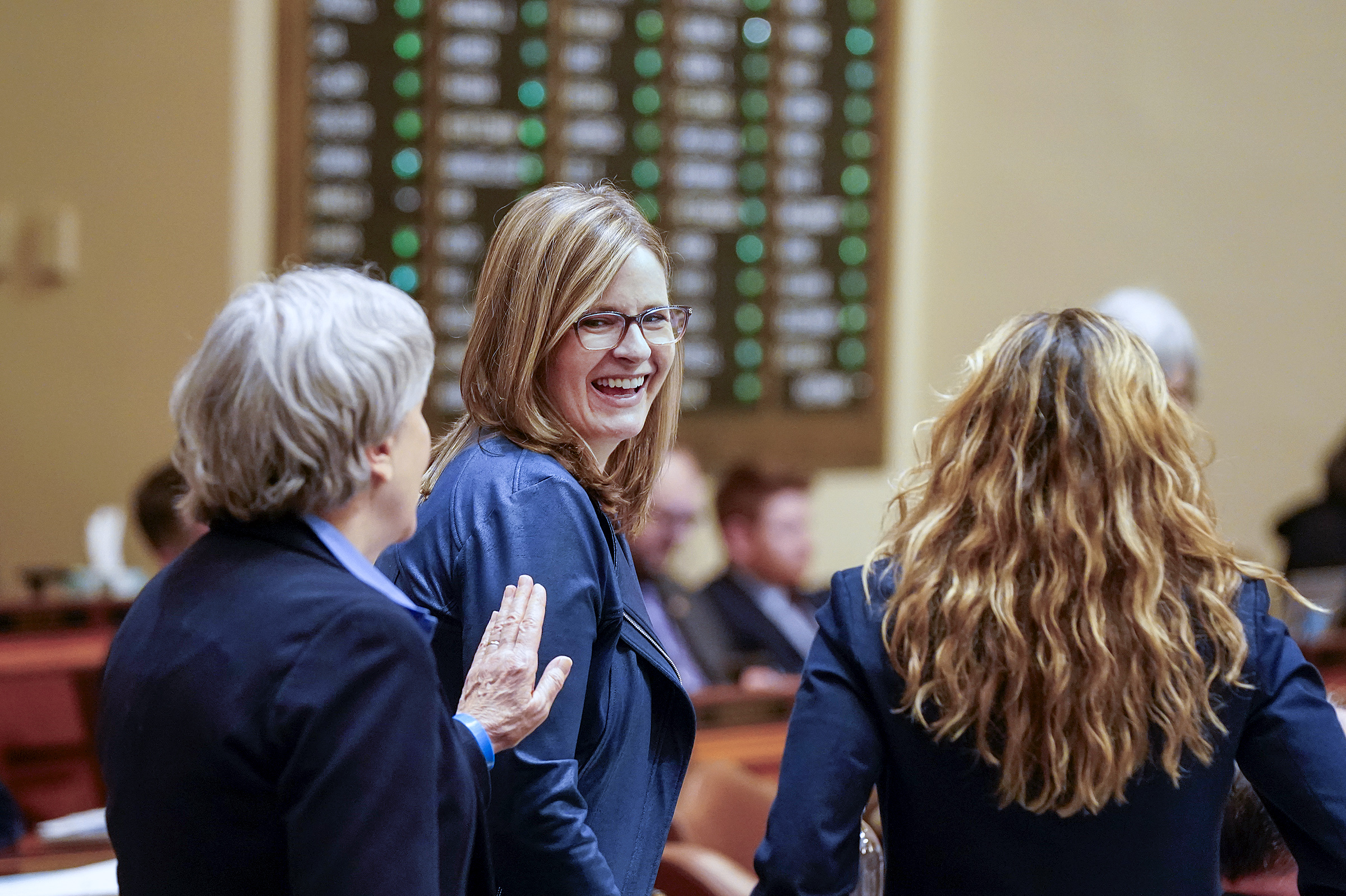 Rep. Kelly Moller is congratulated by Rep. Laurie Pryor following the passage of HF3614, the public safety policy bill. The April 8 vote was 130-0. (Photo by Michele Jokinen)